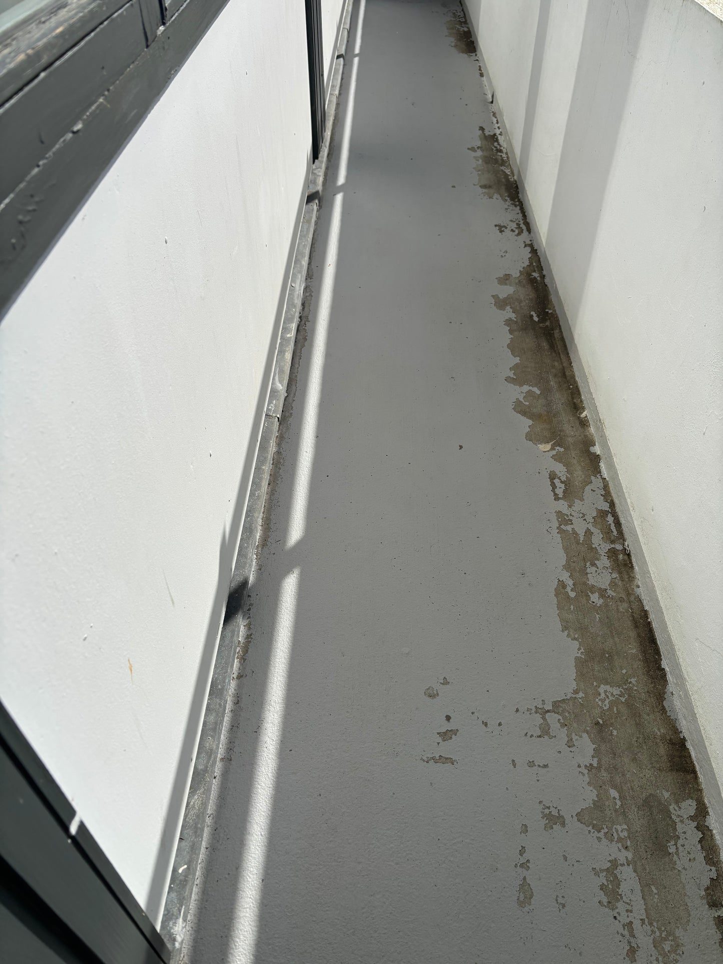 Dirty balcony floor showing stains and wear, requiring professional cleaning services in Copenhagen.