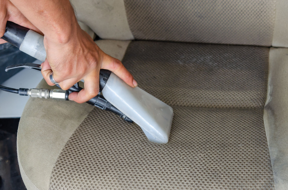 Fabric car seat cleaned with an injection-extraction machine